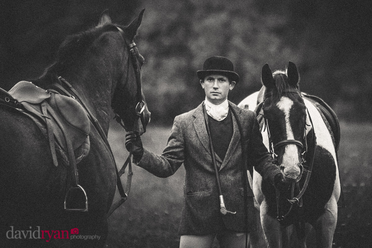 man holding two horses