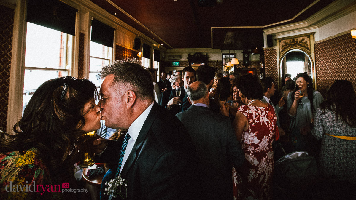 a couple kissing in a pub
