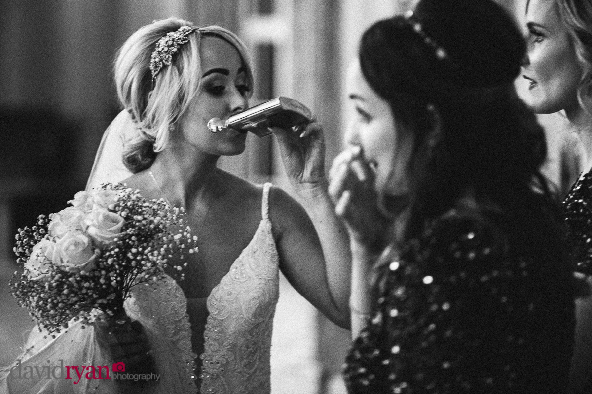 bride drinking from a hip flask
